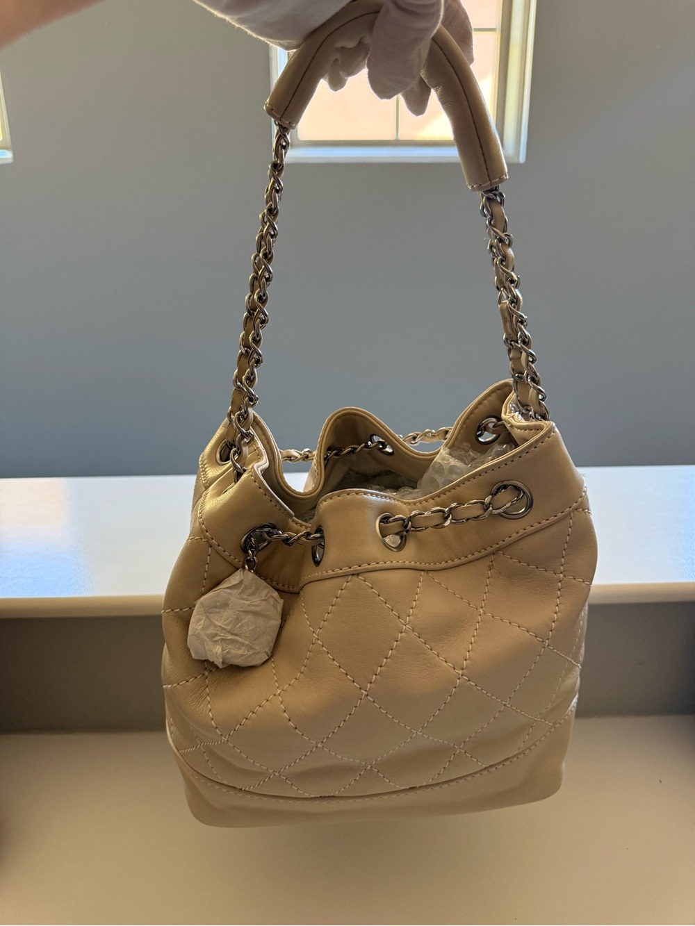 Authentic Chanel Surpique Lambskin Small Bucket Bag in Cream